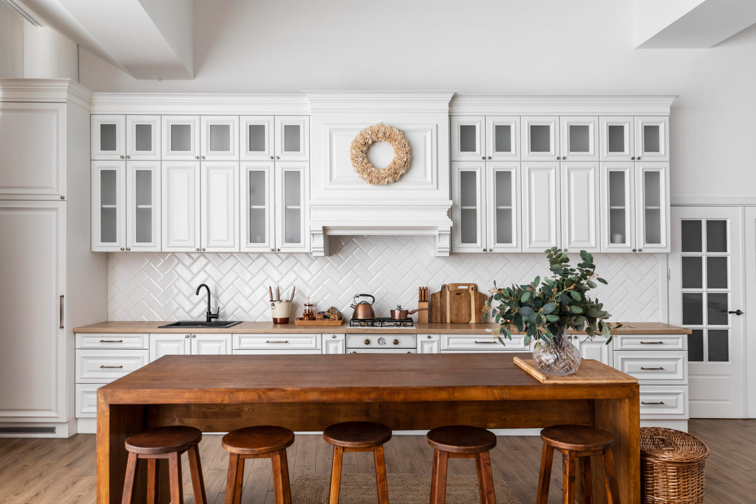 Experience the best kitchen interior designs with a rustic charm of wooden dining table and stools, complementing the contemporary white-themed straight kitchen. Perfect blend of style and functionality .
